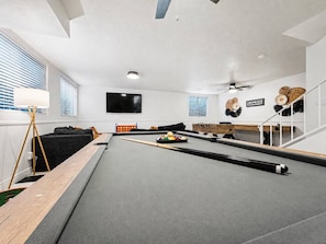 A pool table with a billiard cue, balls, and a pool table cover. - Peoria Home | Pool | Game Room (Peoria)