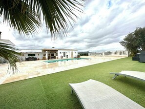 A residential property with a swimming pool, a patio area, and a view of the surrounding landscape. - Designed rustic house with glazed porch and pool (Huércal-Overa)