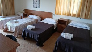 A hotel room with four single beds, a wooden headboard, a small wooden nightstand, a wall-mounted painting, and a window with curtains. - Apartment 'Apartament Cor De Prades' with Sea View, Balcony and Wi-Fi (Mont-ral)