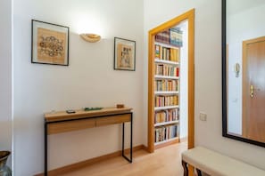 A room with a desk, bookshelf, and a door leading to another area. - Wake up to a view of the Sagrada Familia (Barcelona)