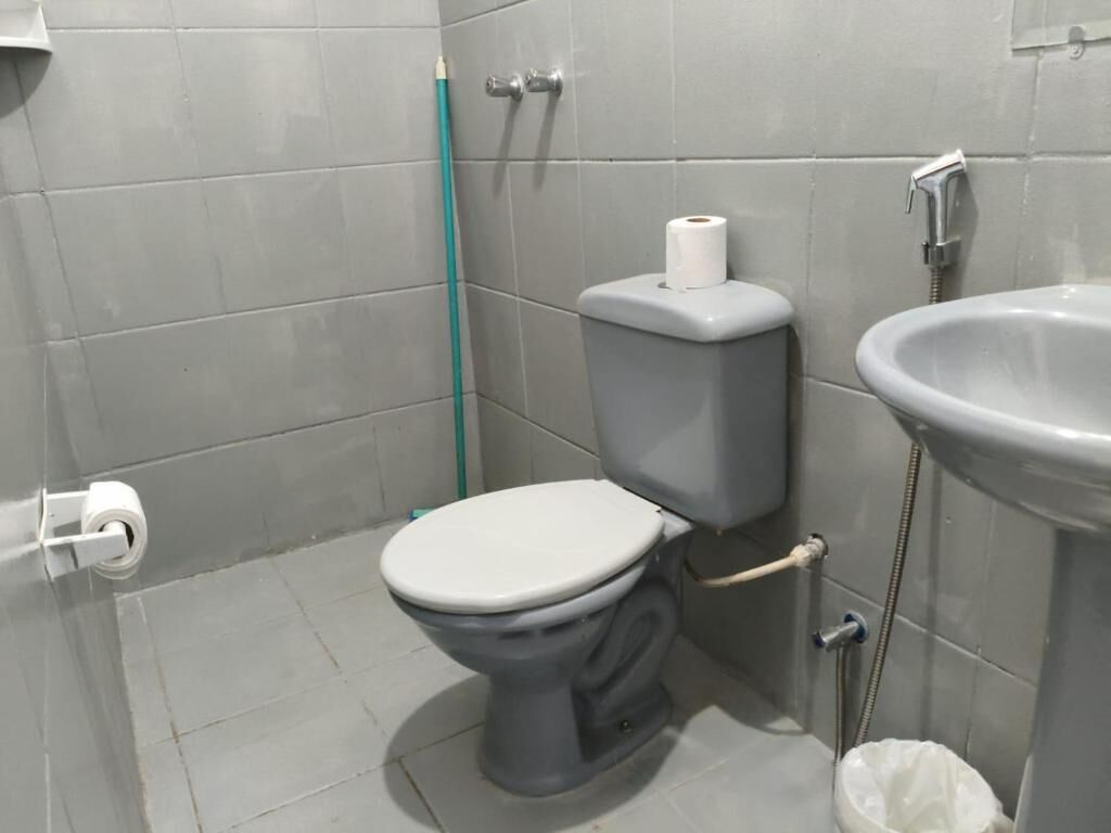 Een badkamer met toilet, wastafel en douche.