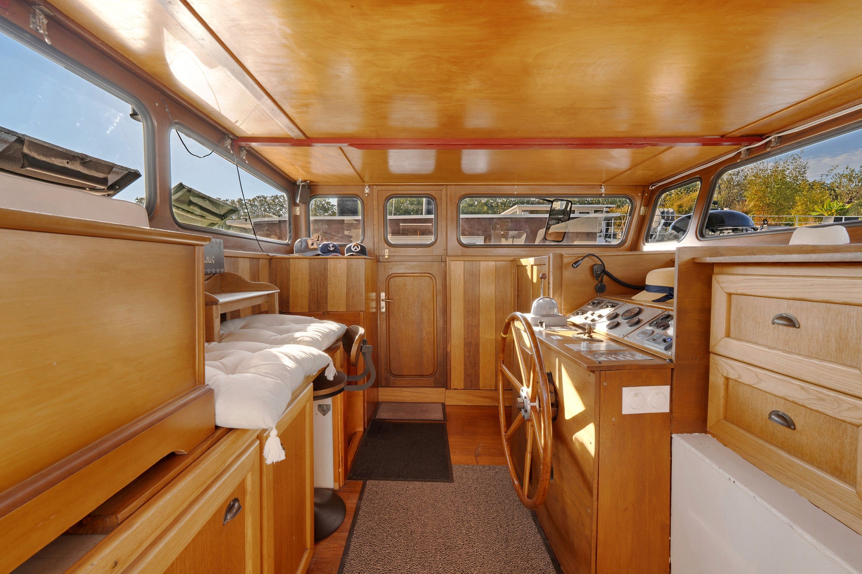 A compact galley with wooden cabinetry, a small sink, and a stove.