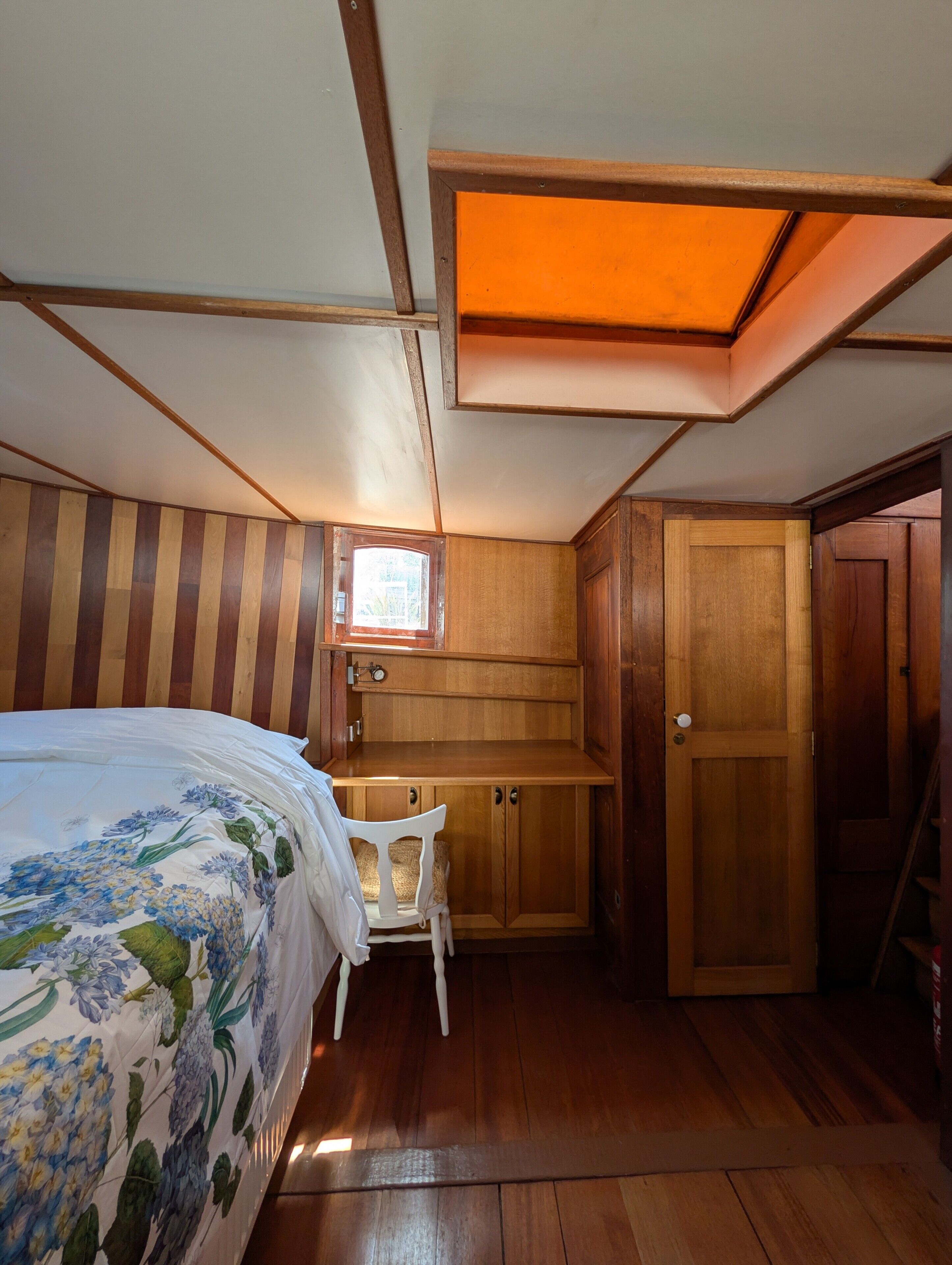 Un dormitorio con cama, escritorio y armario.