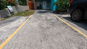 A parking area with a concrete surface and yellow lines. - 2br Ground Floor, Sleeps 8, Pets Ok - Spi 2 Bedroom Apts (South Padre Island)