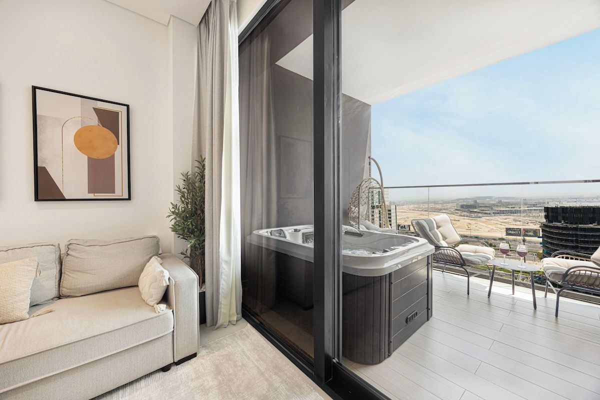 A modern living room with a sofa, a hot tub, and a balcony with a view of the city.
