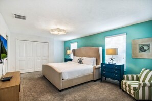 A bedroom with a bed, a dresser, a chair, and a window with blinds. - 6BR Modern Disney area -ChampionsGate Pool/Spa Villa- Game Room (Davenport)