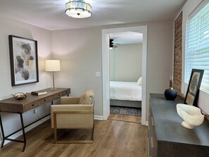 A modern room with a desk, chair, bedside table, lamp, and a bed. - Newly renovated 1-bedroom apartment in pleasant Gamaliel (Gamaliel)