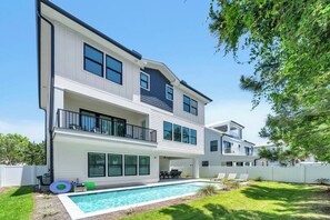 A two-story house with a swimming pool, a covered patio, and a fenced backyard. - 30A House Co: The Henderson House (SANTA RSA BCH)
