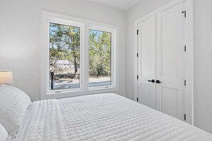 A bedroom with a bed, a window, and a door. - 30A House Co: The Henderson House (SANTA RSA BCH)