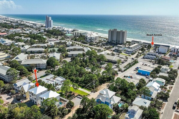 A coastal residential area with a beach access point, surrounded by houses and buildings. - 30A House Co: The Henderson House (SANTA RSA BCH)