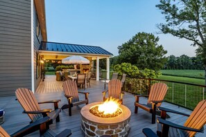 A deck with outdoor seating and a fire pit. - Welcome to the magic of Langford Creek Farm (Chestertown)