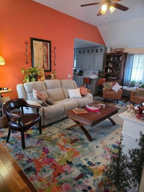 A living room with a sofa, armchairs, a coffee table, and a fireplace. - Cozy 2 Bedroom Suite walking distance to downtown (Rutland)