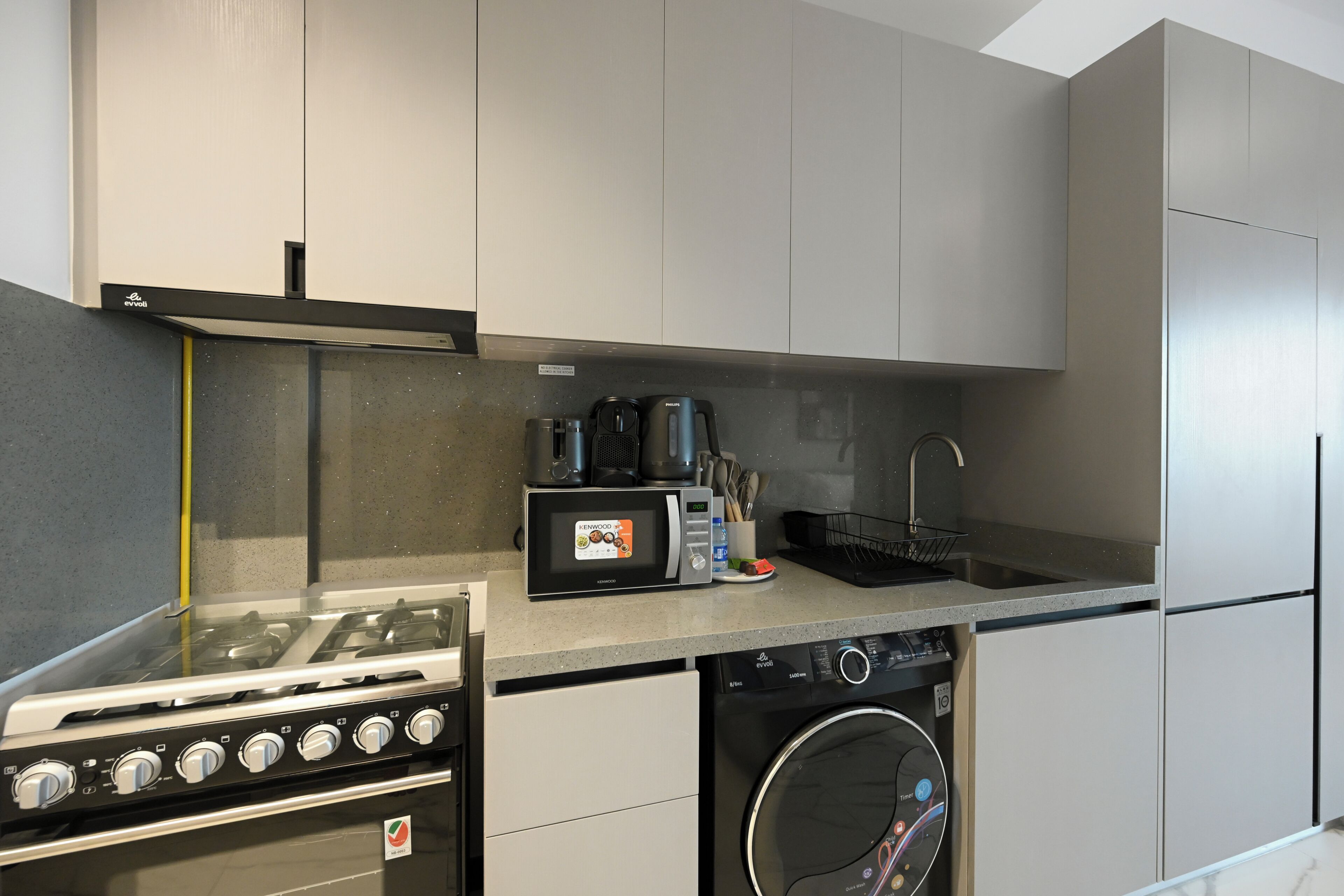 A compact kitchen with a built-in stove, microwave, and dishwasher.