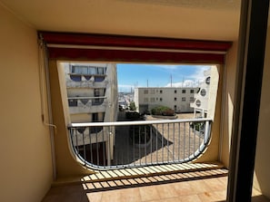 A balcony with a view of a residential area, including buildings and a marina. - Coeur de ville, studio avec parking N73 (La Grande-Motte)