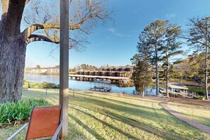 A lakeside view with a dock, a chair, and a gazebo. - 4BR Spacious Lakefront Retreat with Game Room (Hot Springs)