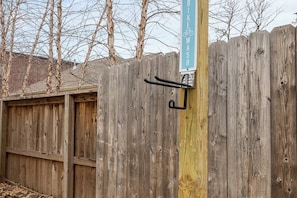 A wooden fence with a bike wash sign and a bike rack attached to it. - B Street Bungalow | Bike-In/Bike-Out & Game Room (Bentonville)
