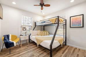 A bunk bed room with a desk, chair, and a ceiling fan. - B Street Bungalow | Bike-In/Bike-Out & Game Room (Bentonville)