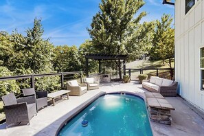 A swimming pool with lounge chairs and a pergola, surrounded by trees. - 5BR Spacious family retreat with pool, BBQ grill (Rogers)