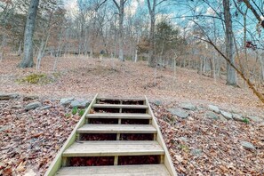 A wooden staircase leading up a hill in a forested area. - 4BR Waterfront - Screen-in Deck (Eureka Springs)