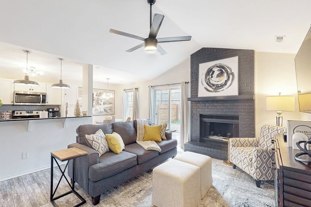 A modern living room with a fireplace, a sofa, and a coffee table.