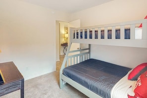 A bedroom with a bunk bed, a small desk, and a nightstand. - OZK Trail House | Downtown, Bikes & Dogs (Bentonville)
