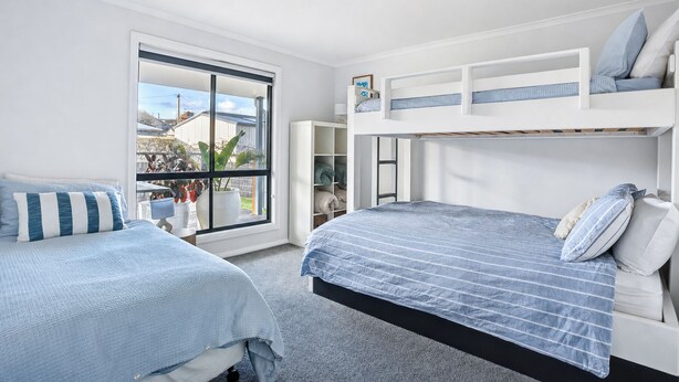 A bedroom with bunk beds, a window with a view, and a door leading to a closet. - Stones Throw - Located right in the heart of Robe (Robe)