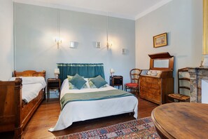 A traditional bedroom with a wooden bed, two bedside tables, a dresser, a chair, and a mirror. - Bed and Breakfast 'Chambre Esclarmonde' with Shared Pool, Shared Garden and Wi-Fi (Carcassonne)