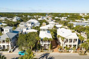 A residential area with multiple houses, some with balconies, and a road in the foreground. - When you need a getaway, Beach Therapy is the cure! (Panama City Beach)