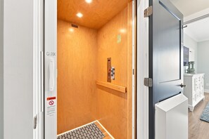 An elevator with a wooden interior and a control panel. - Emerality | Steps to Beach, Private Elevator (Emerald Isle)