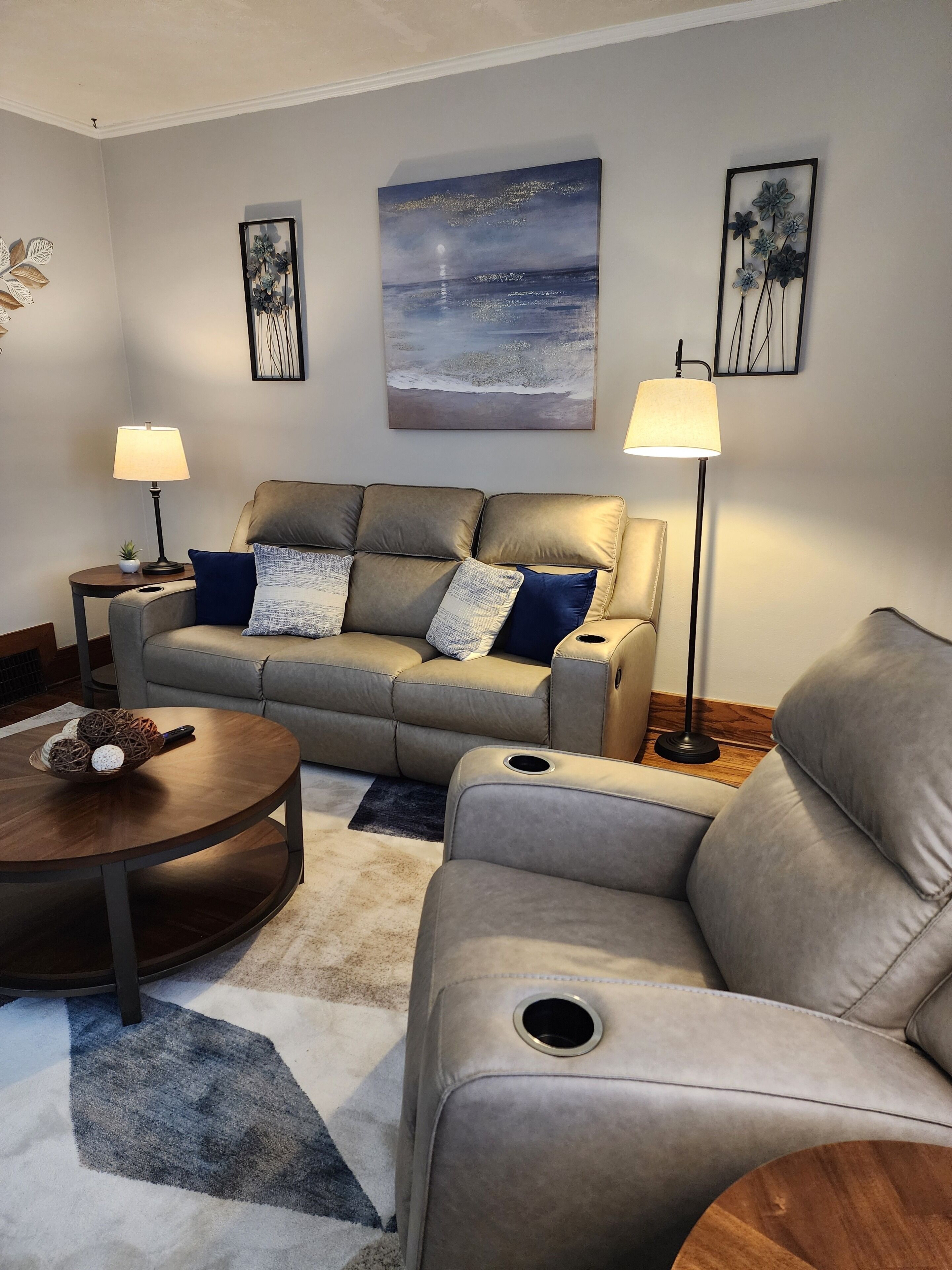 A living room with a sofa, two side tables, a coffee table, and a rug.