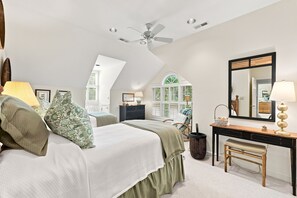 A bedroom with a bed, a desk, a chair, a ceiling fan, and a window with shutters. - Fore Seasons Wonderful 5BR home in DeBordieu w/ super location, great porches (Georgetown)