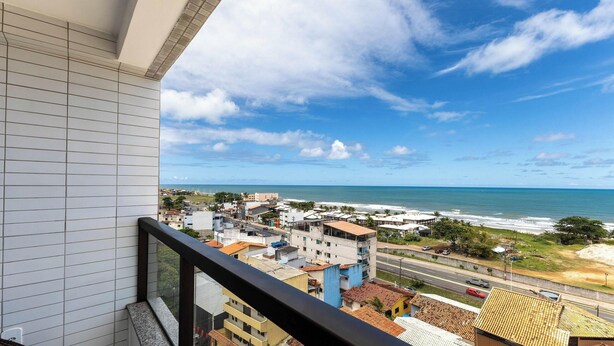 A balcony with a view of a coastal town, buildings, and the ocean. - Apt Sea View 300 m From the Beach Mmd0802 (Ilhéus)