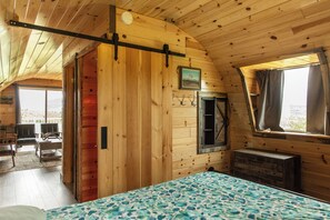 A cozy wooden cabin room with a bed, a desk, a chair, and a window with curtains. - Glacier Aurora - Stargazing Wonder overlooking the Forest and the East Rockies (Babb)