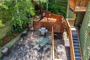 A patio with a grill, outdoor seating, and a wooden fence. - Mountain Comfort at Ski Ranch 103 – Easy Access to Slopes & Town! (Steamboat Springs)