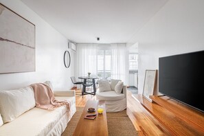 A modern living room with a sofa, coffee table, and a flat-screen TV. - HESTIA STAYS AT CABELLO 3600 (Buenos Aires)