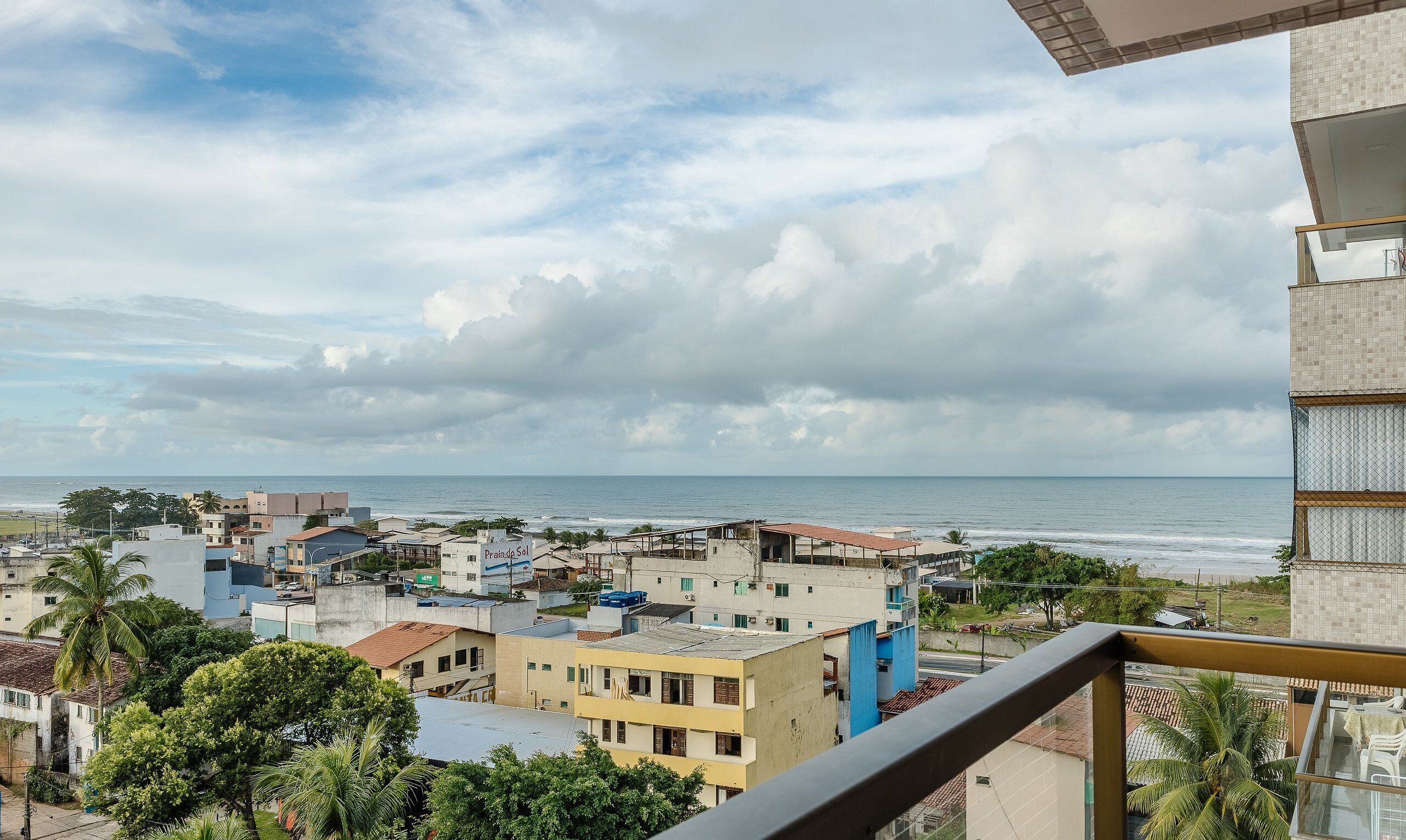 A coastal cityscape with buildings and a view of the sea.