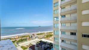 A high-rise building with multiple balconies overlooking a beach and ocean. - Apt w/ Balcony, BBQ & sea View Shc0801 (Picarras)