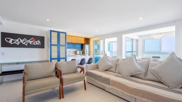 A modern living room with a sofa, two armchairs, a dining area with a table and chairs, and a kitchen with blue cabinets. - Apt w/ Balcony, BBQ & sea View Shc0801 (Picarras)