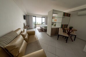 Unwind in a spacious studio with bed, sofa, and ocean light. - Beachside Suite w/ Balcony - Ultimate Relaxation Steps From Cabo Branco Beach! (Paraíba)