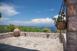 A stone patio with a view of the sea and greenery. - Koroni Akrita Residence, Sfaktiria Pooliside Nest (Koroni)