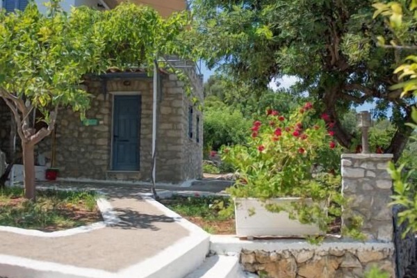 Charming stone pathway and steps surrounded by lush Mediterranean plants and traditional architecture.