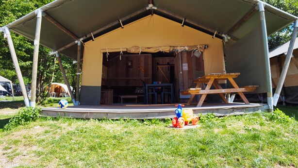 A tent with a covered porch, wooden benches, and a picnic table. - Vacation home by Interhome (Osecná)