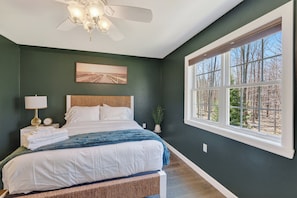 Cozy woodland-view bedroom with stylish decor and abundant natural light - Forest Moon - Peaceful Pet-Friendly Wooded Retreat (Egg Harbor)
