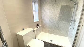Shower, hair dryer, towels, soap