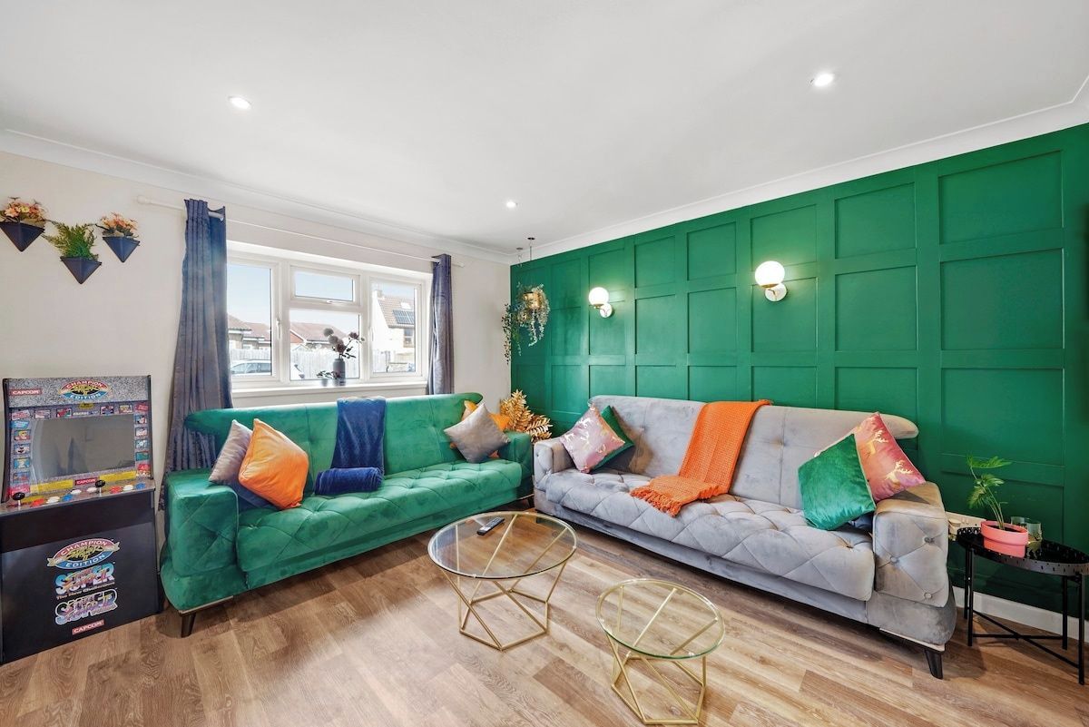 A living room with two sofas, a coffee table, and a gaming console.