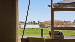 A room with a window overlooking a body of water and a grassy area. - 25 Captain Sturt Rd, Hindmarsh Island (Hindmarsh Island)