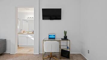 A modern office space with a desk, chair, and a laptop.