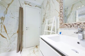 A bathroom with a white marble wall, a white sink, and a mirror with an ornate frame. - Oasi del Garda in Desenzano - Pool, Garden, and Garage (Desenzano del Garda)