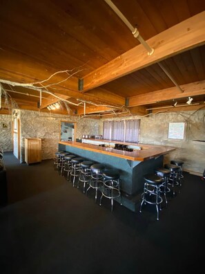 A bar area with stools and a trash bin. - Winterplace condo lodge - Ski in Ski out (Raleigh County)