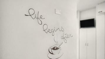 A wall with a motivational quote and a coffee cup illustration.